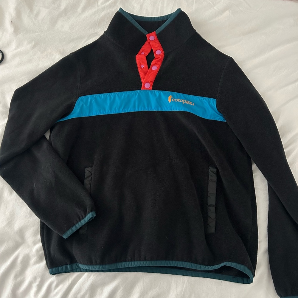Cotopaxi Black Fleece with Blue and Red Highlights
